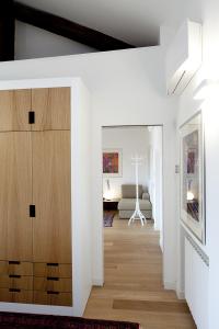 a living room with white walls and wooden cabinets at Parco Sempione in Milan