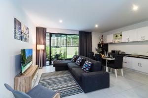 a living room with a couch and a table at Pause on Samui Residences in Bophut