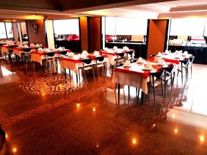 a dining room with tables and chairs in a restaurant at Business Park Hotel in Ankara