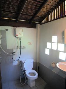 a bathroom with a toilet and a sink at Phanom Bencha Mountain Resort in Krabi