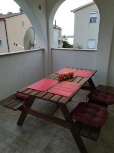 a picnic table on a balcony with a mirror at Tramonto in Medulin