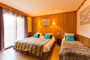 Postel nebo postele na pokoji v ubytování Hôtel Les Airelles