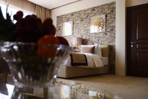 - une chambre avec un lit et une table avec un vase dans l'établissement Lumiere Des Etoile, à Koweït