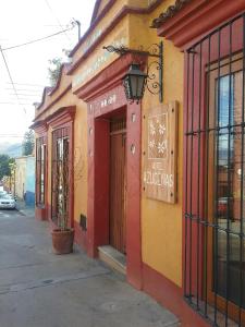 a building with a sign on the side of it at Hotel Azucenas in Oaxaca City