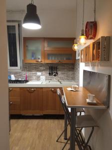 a kitchen with wooden cabinets and a table with chairs at affitto turistico San Pietro in Rome