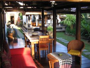 a patio with a wooden table and chairs at Puri Ayu in Canggu