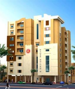 a large building in front of a building at Ramee Suite Apartment 4 in Manama