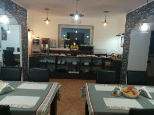a dining room with two tables and a counter at Euro Hotel in Timişoara