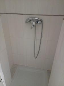 a shower with a shower head in a bathroom at Alfaqueque Apartment in Seville