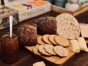 a wooden cutting board with bread and cookies on it at Järnvägshotellet in Gävle