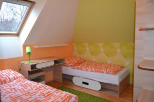 a small bedroom with two beds and a desk at Elizabet in Bojnice