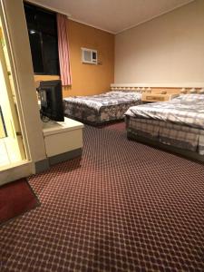 Ένα ή περισσότερα κρεβάτια σε δωμάτιο στο Ya Shi Deng Hotel