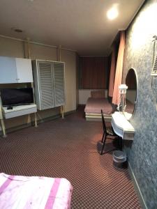 Ένα ή περισσότερα κρεβάτια σε δωμάτιο στο Ya Shi Deng Hotel