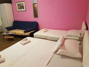a room with two beds and a couch at Vila Angela in Split