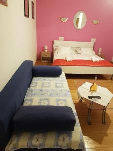 a living room with a couch and a bed at Vila Angela in Split
