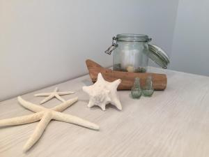 a table with two starfish and a jar on it at Meeresbrise in Laboe