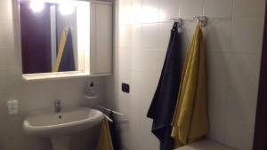 a bathroom with a sink and a shower with a window at Casa Matilde in Vercana