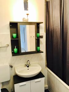 a bathroom with a sink and a mirror at Apartment Sweet in Hannover