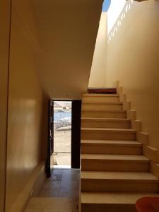 a staircase leading up to a room with the beach at Keka Nubian House in Aswan