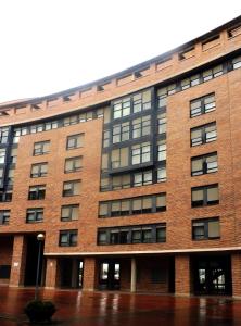 a large brick building with windows at Ático en Pamplona in Barañáin