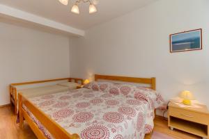 Postel nebo postele na pokoji v ubytování Apartmani Dorita