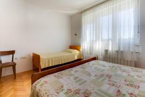 Postel nebo postele na pokoji v ubytování Apartmani Dorita