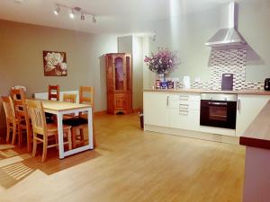 a kitchen and living room with a table and chairs at Yvi's 2-3 Bedroom Town Apartment in Inverurie