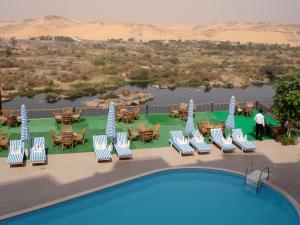 a resort with a pool and chairs and tables at Sara Hotel Aswan in Aswan