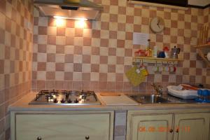 a kitchen with a stove and a sink at Appartamenti al mare in SantʼAntìoco +87 photos