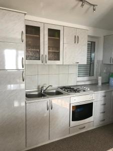 a kitchen with a sink and a stove at Home Coric in Posušje
