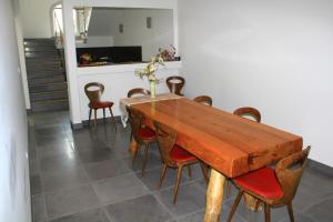 a dining room with a wooden table and chairs at L'Attrachju in Corte