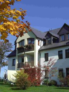 ベーレンシュタインにあるApartment fewobaerensteinのバルコニー付きの広い白い家