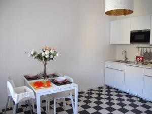 a kitchen with a white table with flowers on it at Il Capitano in Lerici +27 photos