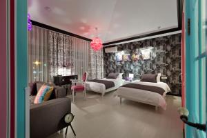 a bedroom with two beds and a living room at De Gaulle Boutique Hotel in Kharkiv