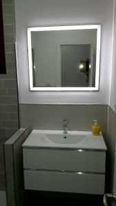 a bathroom with a white sink and a mirror at La Pandorga in Sanlúcar de Barrameda +20 photos