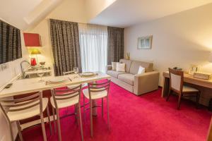 a living room with a table and a couch at Hotel Boutique Belvedere in Sinaia