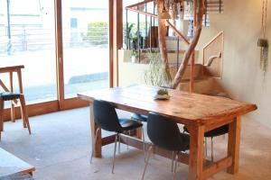 a wooden table and chairs in a room at Ruco in Hagi