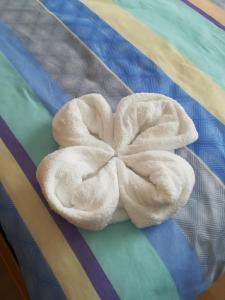 a white towel sitting on top of a bed at Tramonto in Medulin