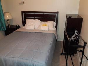 a bed in a room with a wooden headboard at Studio and 1 Bedroom Apartments - Bronx in Bronx