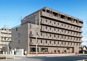 a large building on the corner of a street at The Kato Hotel in Tokai