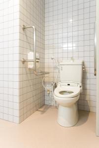 a bathroom with a white toilet in a stall at The Kato Hotel in Tokai
