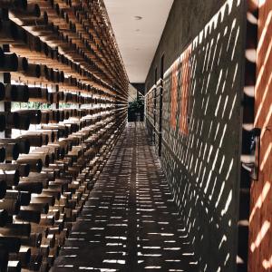 a long aisle of wine racks in a wine cellar at Inchantreedoopool in Kanchanaburi City