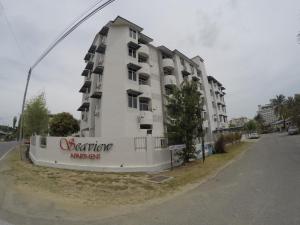 a large white apartment building on the side of a street at Seaview Apartment in Kuah