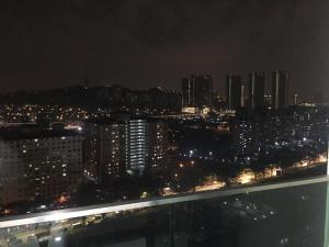 a view of a city at night with lights at JV HOMESTAY - 2 Rooms Condominium Home Stay at Jalan Klang Lama in Kampong Bohol