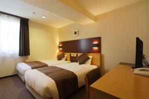 Postel nebo postele na pokoji v ubytování Ueno First City Hotel