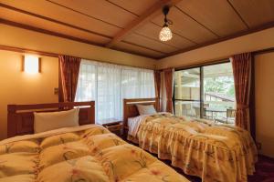 Postel nebo postele na pokoji v ubytování Izumigo AMBIENT Yatsugatake Cottage