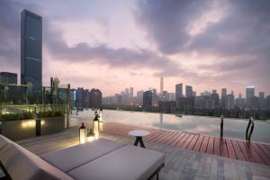 a rooftop patio with a view of a city skyline at Fraser Suites Shenzhen, Near Huaqiang North Business Zone and next to shopping mall complex, with direct subway access in Shenzhen