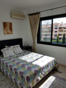 a bedroom with a bed and a large window at Kings Avenue - Natalia's Apt in Paphos