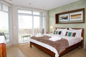 a bedroom with a large bed with towels on it at Atlantik Sicht Apartment in Swakopmund