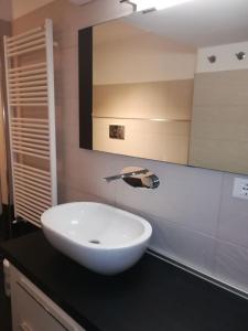 a bathroom with a white sink and a mirror at Posidonia Cinque Terre Guesthouse in Manarola